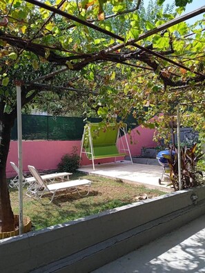 Garden with sunbeds and swing