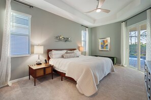 Master bedroom sliding door to enclosed lanai with pool and hot tub