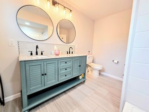 Bathroom with double sinks and shower/tub combo