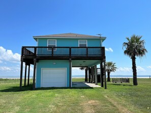 House from the main street showing the wrap around deck on 3 sides.