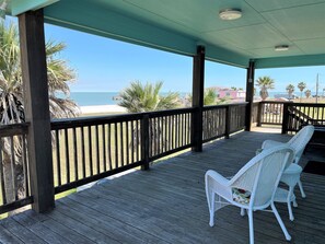 Large covered deck with view of the bay and the sunrise. 