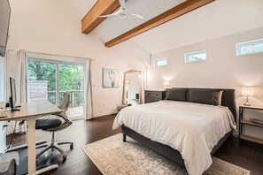 Spacious primary bedroom with a king-sized bed and an en-suite bathroom.
