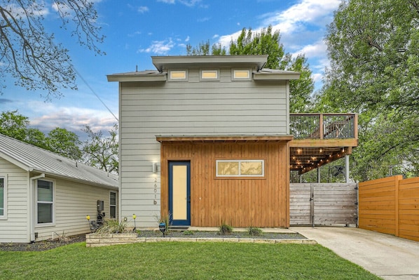 Inviting front entry with lush greenery and a well-maintained lawn.