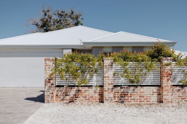 Front of the property with fully fenced yard
