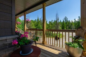 Relax on the covered front deck with morning coffee or evening wine, surrounded by nature and fresh forest air.