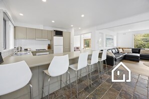 Well-equipped kitchen and breakfast bar with seating for 5