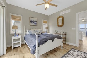 The first-floor master bedroom, with a private exterior entrance, is quietly located off the kitchen and dining area, featuring an attached bathroom and breathtaking views.
