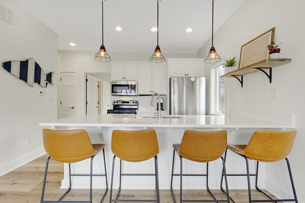 The newly renovated kitchen features modern updates and everything you need to cook, gather, and relax.