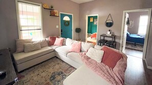 Kick back in a cozy living room with plush pillows, soft blankets & a Smart TV