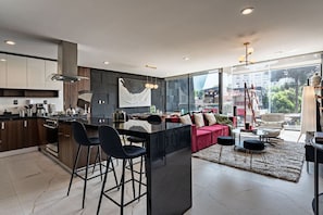 Modern kitchen and breakfast bar just steps from the cozy living area