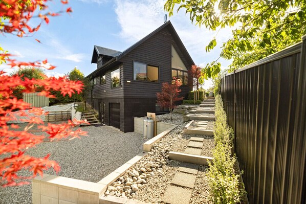 Modern design meets nature with vibrant landscaping and stunning views in Arrowtown!