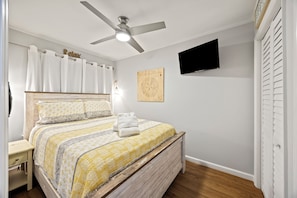 Sleep soundly on a queen bed with a plush mattress topper and blackout shades.