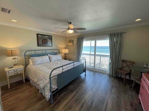 Primary King Bedroom with smart TV, coffee station and private balcony.