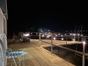 Serene, roomy deck with multiple seating areas and fire pit
