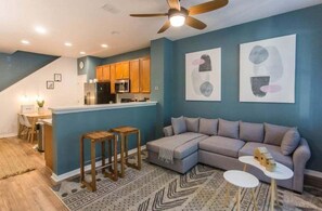 Kick back and relax in a large, comfortable living room designed for quality time. Whether it's movie night, game night, or just lounging around, there's plenty of space for everyone to gather and unwind.