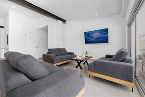 Kick back and enjoy a movie in ultimate comfort! Our spacious living room features a cozy sofa, perfect for lounging while you unwind and catch your favorite shows.