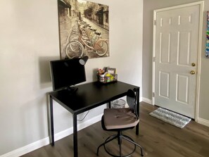 Desk and monitor with supplies.
