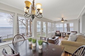 This spacious living area, with its comfortable seating and stunning views, offers the perfect place to relax and take in the beauty of the lake. A serene setting for your next getaway.