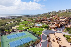 Amenities include two pools, hot tubs, two tennis courts, and a four-acre park with a sand volleyball court and a children's playground!