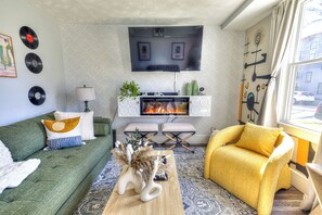 Living room with TV and fireplace