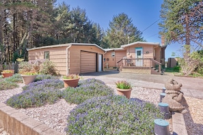 Cozy front deck and beautifully landscaped yard.