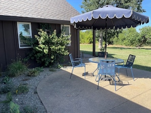 The front patio spills into the lawn.