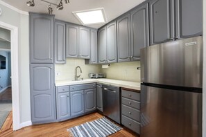 Kitchen with full size refrigerator, sink and dishwasher