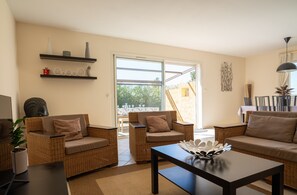 Air-conditioned lounge with television, sofa and wifi