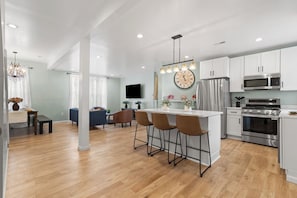The kitchen is fully equipped with cookware, tableware and cooking condiments