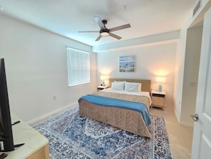 Primary bedroom with king bed, 50-inch Smart TV and attached bathroom