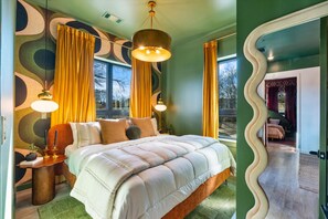 Unique and stylish bedroom featuring a statement wall and comfortable furnishings