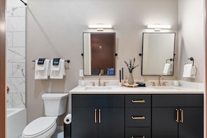 Modern bathroom with double vanity, sleek finishes, and ample space.