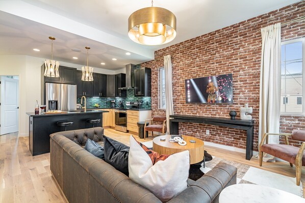 1st Unit - 2nd Floor: Open-floor living space featuring a Smart TV and designer furnishings.