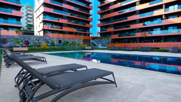 Relax in Funchal with stunning ocean views and a beautiful pool. Enjoy sun loungers by the water in this stylish apartment for a perfect and peaceful getaway. #funchal #apartment #luxury