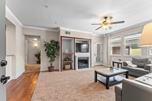 Light-filled living room with cozy seating and a fireplace—the perfect spot to unwind after a day in Reno.