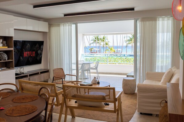 Living room: Bright and spacious, featuring central air and stunning views of the pool and beach.