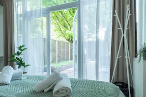 Wake up to greenery and fresh air with direct access to a private outdoor space — perfect for a peaceful start to your day.