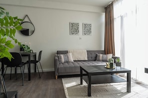 Relax in this stylish living space filled with natural light, cozy decor, and modern touches.