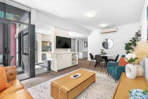 Relax in our bright living space, with comfy chairs and a glass doors open to your balcony getaway.