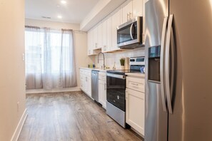 Sleek, minimalist kitchen with clean lines, high-end appliances, and ample storage, ideal for the discerning traveler seeking comfort and functionality.