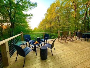 Huge deck with dining area, wood burning fire pit and charcoal grill