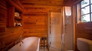 A beautifully crafted bathroom with natural wood accents offers a tranquil space to refresh and unwind.