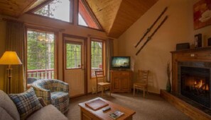 Vaulted ceilings, warm wood accents, and a cozy fireplace create the perfect space to unwind after a day in the mountains.