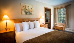 Soft lighting, warm tones, and a plush bed create a restful retreat after a day of mountain adventures.