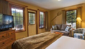 Large windows invite natural light and breathtaking views, making this cozy space feel bright and welcoming.