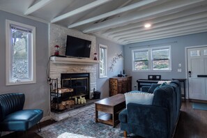 Cozy gathering areas in the living room around the fireplace or next to the keyboard.
