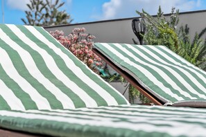 Outdoor area featuring a barbecue, sun-soaked solarium, and a dining table