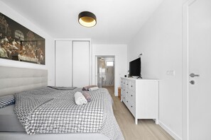 Spacious suite bedroom featuring one king-size bed, a private bathroom
