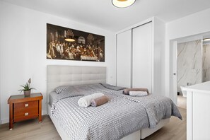 Spacious suite bedroom featuring one king-size bed, a private bathroom