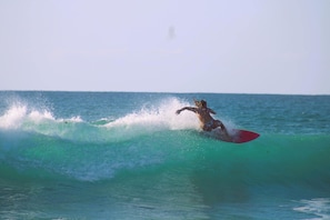 Owner's daughter riding the waves